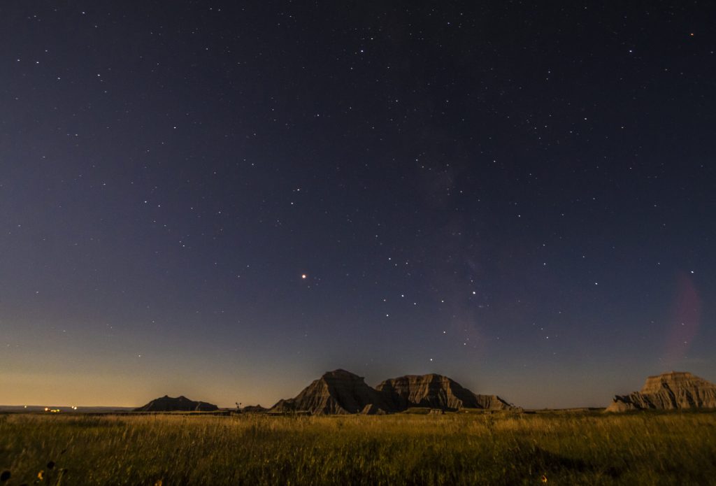 spectacular summer night sky in South Dakota's famous geologic rock formation in Badlands national Park .